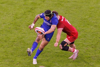 140326 - Wales v Italy - Guinness Six Nations - Juan Ignacio Brex of Italy kicks as he comes under pressure from Alex Mann of Wales