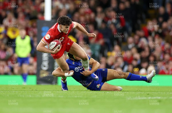 140326 - Wales v Italy - Guinness Six Nations Championship - Eddie James of Wales is tackled by Juan Ignacio Brex of Italy 
