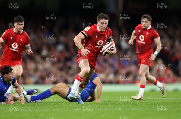 140326 - Wales v Italy - Guinness Six Nations Championship - Josh Adams of Wales breaks past Monty Ioane of Italy 