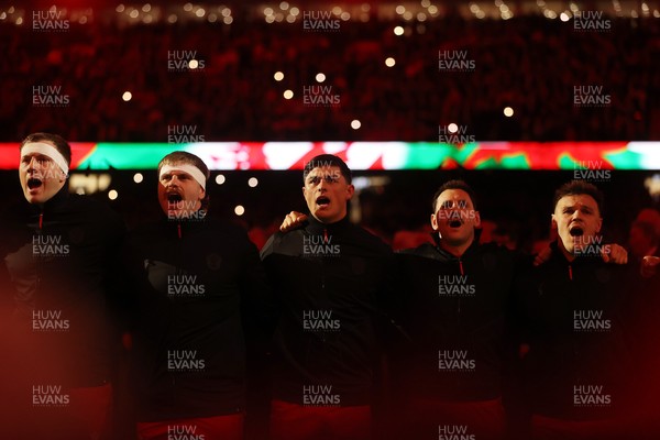140326 - Wales v Italy - Guinness Six Nations Championship - Ben Carter, Aaron Wainwright, Louis Rees-Zammit and Tomos Williams of Wales sing the anthem