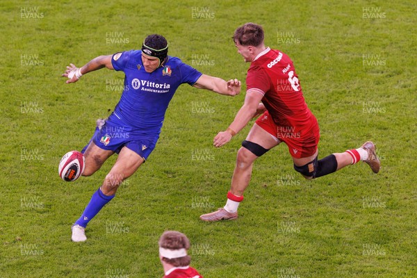 140326 - Wales v Italy - Guinness Six Nations - Juan Ignacio Brex of Italy kicks as he comes under pressure from Alex Mann of Wales