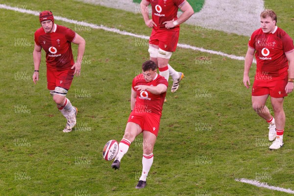 140326 - Wales v Italy - Guinness Six Nations - Jarrod Evans of Wales kicks for touch