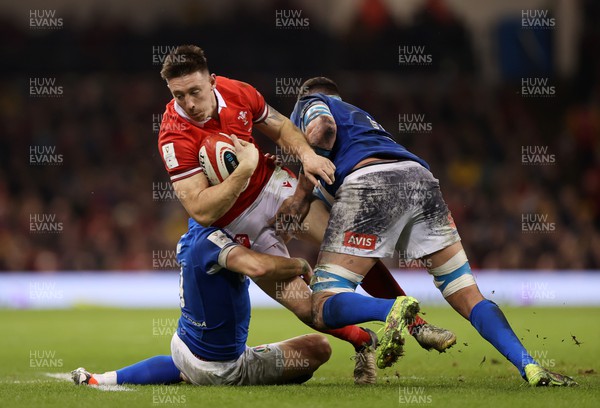 160324 - Wales v Italy - Guinness 6 Nations 2024 - Josh Adams of Wales is tackled by Stephen Varney and Sebastian Negri of Italy 