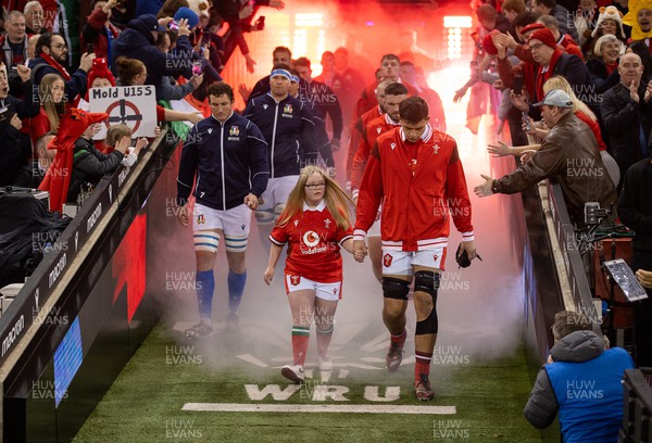 160324 - Wales v Italy - Guinness 6 Nations 2024 - Dafydd Jenkins of Wales walks out with the mascot