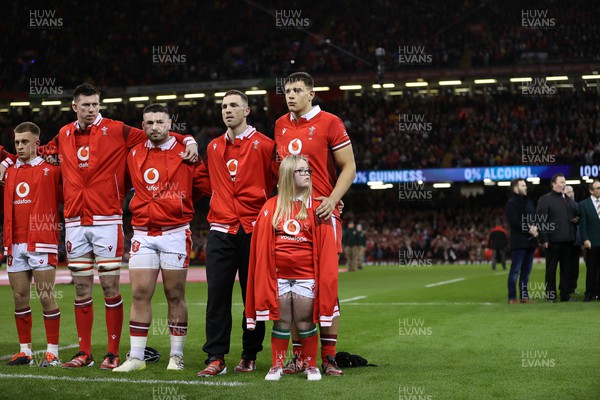 160324 - Wales v Italy - Guinness 6 Nations 2024 - Dafydd Jenkins of Wales walks out with the mascot