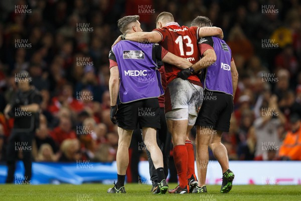 160324 - Wales v Italy - Guinness Six Nations - George North of Wales is helped off the pitch after getting injured