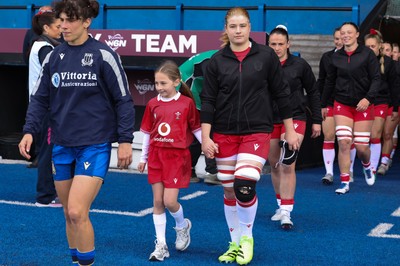 170526 - Wales v Italy, 2026 Guinness Women’s 6 Nations - Bethan Lewis of Wales walks out with the match mascot at the start of the match