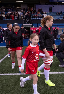 170526 - Wales v Italy, 2026 Guinness Women’s 6 Nations - Bethan Lewis of Wales walks out with the match mascot at the start of the match