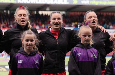170526 - Wales v Italy, 2026 Guinness Women’s 6 Nations - Hannah Dallavalle of Wales, Jasmine Joyce of Wales and Alisha Joyce of Wales during the anthems