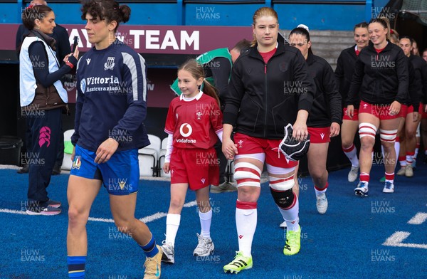 170526 - Wales v Italy, 2026 Guinness Women’s 6 Nations - Bethan Lewis of Wales walks out with the match mascot at the start of the match
