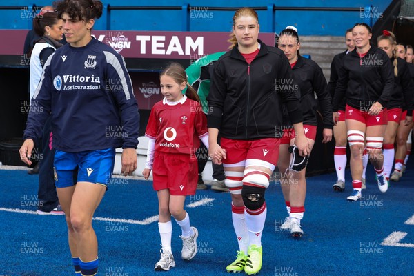 170526 - Wales v Italy, 2026 Guinness Women’s 6 Nations - Bethan Lewis of Wales walks out with the match mascot at the start of the match