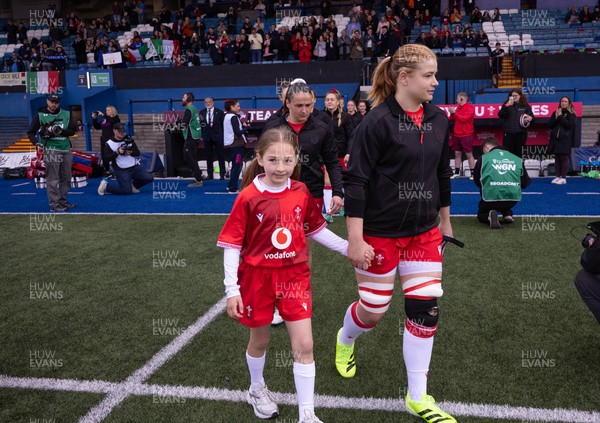 170526 - Wales v Italy, 2026 Guinness Women’s 6 Nations - Bethan Lewis of Wales walks out with the match mascot at the start of the match