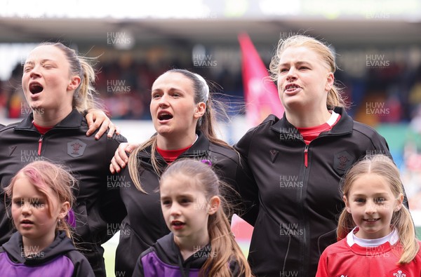 170526 - Wales v Italy, 2026 Guinness Women’s 6 Nations - Alisha Joyce of Wales Kayleigh Powell of Wales and Bethan Lewis of Wales during the anthems