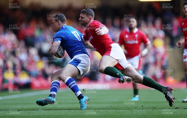 190322 - Wales v Italy - Guinness 6 Nations - Paolo Garbisi of Italy is tackled by Dan Biggar of Wales