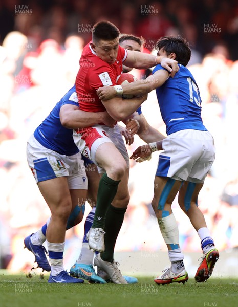 190322 - Wales v Italy - Guinness 6 Nations - Josh Adams of Wales is tackled by Danilo Fischetti and Ange Capuozzo of Italy