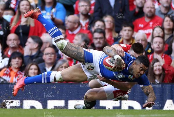 190322 - Wales v Italy - Guinness 6 Nations - Montanna Ioane of Italy is tackled by Josh Adams of Wales