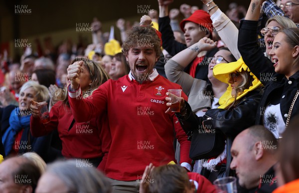 190322 - Wales v Italy - Guinness 6 Nations - Fans celebrate when Wales score a try