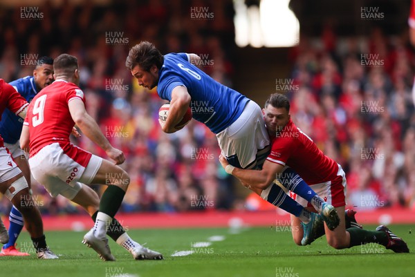 190322 Wales v Italy, Guinness Six Nations 2022 - Giovanni Pettinelli of Italy is tackled by Dan Biggar of Wales