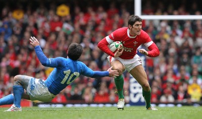19.03.10 Wales v Italy... Wales James Hook is tackled by Italy's Craig Gower. 