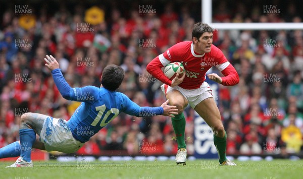 19.03.10 Wales v Italy... Wales James Hook is tackled by Italy's Craig Gower. 