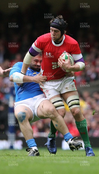 19.03.10 Wales v Italy... Wales Ryan Jones beats tackle by Italy's Martin Castrogiovanni. 