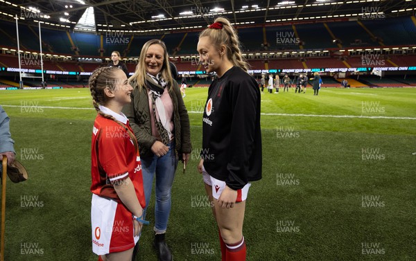 270424 - Wales v Italy, Guinness Women’s 6 Nations - Match mascot Nia Mair Webb chats with Hannah Jones of Wales ahead of the start of the match