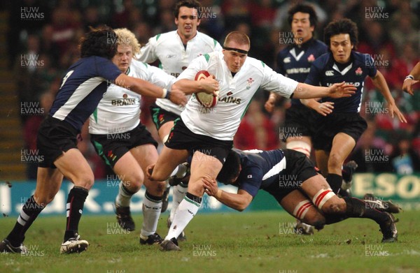 26-11-04. Wales v Japan  Wales' Gethin Jenkins is tackled by Wataru Ikeda.  