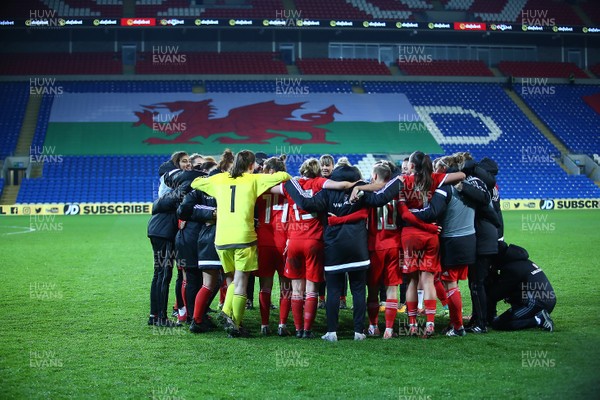 241117 Wales v Kazakhstan - FIFA Women's World Cup Qualifier -   Players and coaches of Wales huddle to celebrate at full time