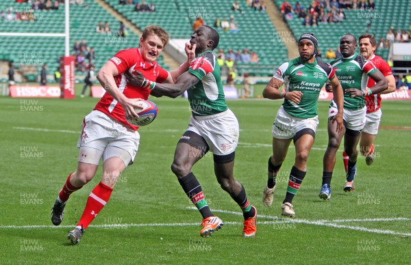 110513 - Wales v Kenya - IRB Sevens England - Dafydd Howells of Wales fends off a tackle from the Kenyan defence 