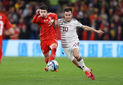 280323 - Wales v Latvia - European Championship Qualifier - Group D - Neco Williams of Wales and Janis Ikaunieks of Latvia challenge for the ball