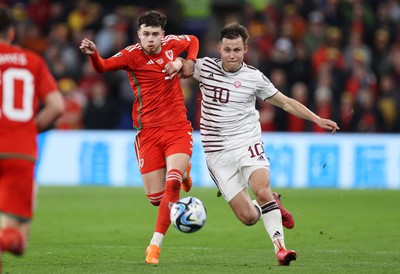 280323 - Wales v Latvia - European Championship Qualifier - Group D - Neco Williams of Wales and Janis Ikaunieks of Latvia challenge for the ball