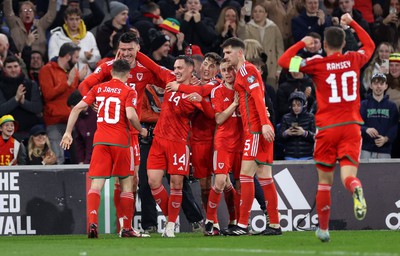 280323 - Wales v Latvia - European Championship Qualifier - Group D - Kieffer Moore of Wales celebrates scoring a goal with team mates