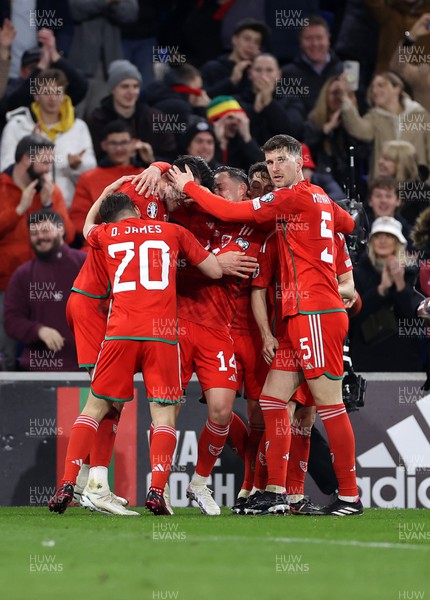 280323 - Wales v Latvia - European Championship Qualifier - Group D - Kieffer Moore of Wales celebrates scoring a goal with team mates