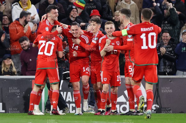 280323 - Wales v Latvia - European Championship Qualifier - Group D - Kieffer Moore of Wales celebrates scoring a goal with team mates