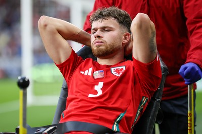 060625 - Wales v Liechtenstein - 2026 FIFA World Cup Qualifying - Neco Williams of Wales leaves field injured