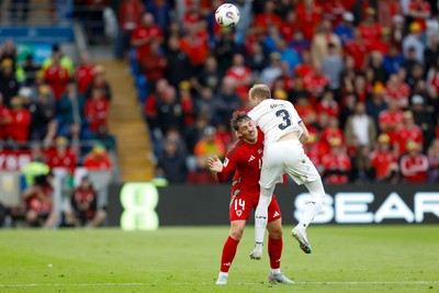 060625 - Wales v Liechtenstein - 2026 FIFA World Cup Qualifying - Connor Roberts of Wales battles for the ball with Max Goppel of Liechtenstein