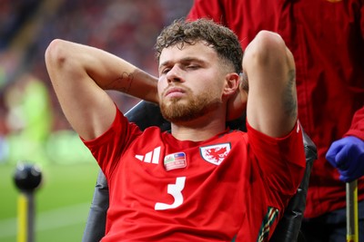 060625 - Wales v Liechtenstein - 2026 FIFA World Cup Qualifying - Neco Williams of Wales leaves field injured