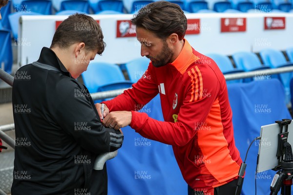 060625 - Wales v Liechtenstein - 2026 FIFA World Cup Qualifying - Josh Sheean of Wales with fan