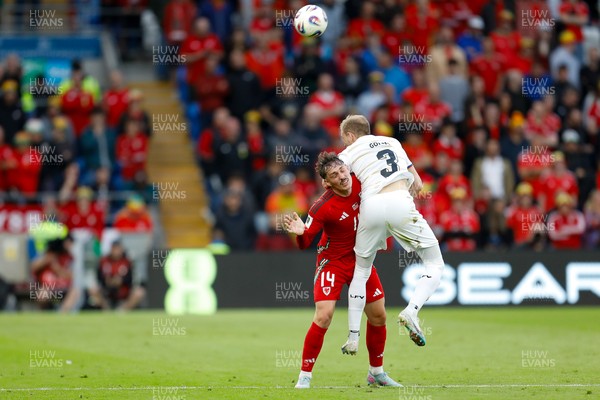 060625 - Wales v Liechtenstein - 2026 FIFA World Cup Qualifying - Connor Roberts of Wales battles for the ball with Max Goppel of Liechtenstein