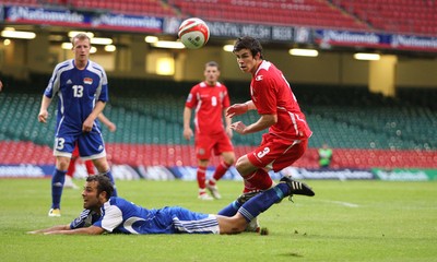 11.10.08 ... Wales v Liechtenstein, World Cup Qualifying Match Group 4, Millennium Stadium, Cardiff - Wales' Gareth Bale is challenged by Liechtenstein's Marco Ritzberger   
