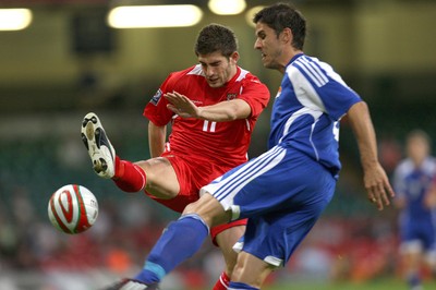 11.10.08 ... Wales v Liechtenstein, World Cup Qualifying Match Group 4, Millennium Stadium, Cardiff - Wales' Ched Evans closes in onLiechtenstein's Martin Stocklasa  