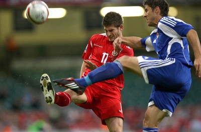 11.10.08 ... Wales v Liechtenstein, World Cup Qualifying Match Group 4, Millennium Stadium, Cardiff - Wales' Ched Evans closes in onLiechtenstein's Martin Stocklasa  
