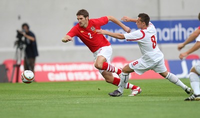 11.08.10 .. Wales v Luxembourg, .Friendly International, Llanelli -  Wales' Sam Ricketts takes on Luxembourg's Gilles Bettmer  