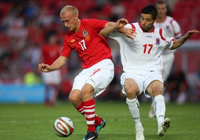 11.08.10 .. Wales v Luxembourg, .Friendly International, Llanelli -  Wales' David Cotterill holds off Luxembourg's Mario Mutsch  