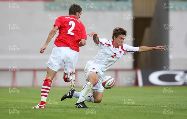 11.08.10 .. Wales v Luxembourg, .Friendly International, Llanelli -  Wales' Sam Ricketts and Luxembourg's Mathias Janisch compete for the ball 