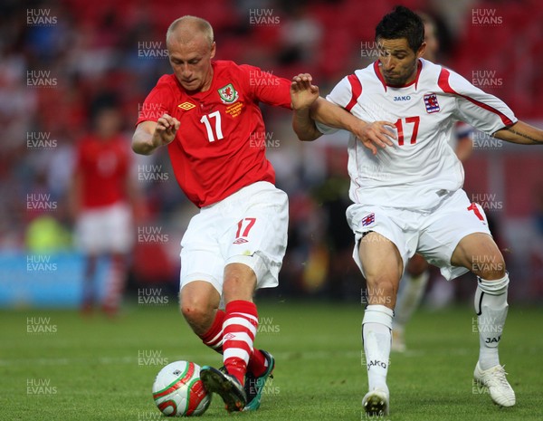 11.08.10 .. Wales v Luxembourg, .Friendly International, Llanelli -  Wales' David Cotterill holds off Luxembourg's Mario Mutsch  