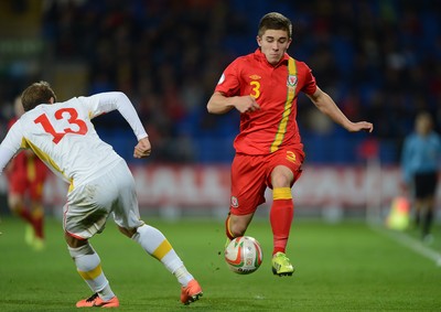 111013 - Wales v Macedonia - FIFA 2014 World Cup Qualifier - Declan John of Wales takes on Stefan Ristovski of Macedonia