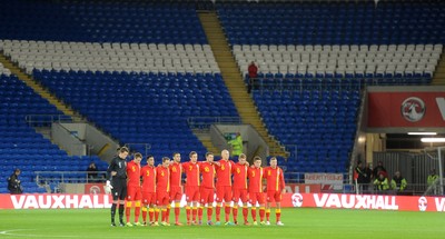 111013 - Wales v Macedonia - FIFA 2014 World Cup Qualifier - Wales players lins up for a minutes silence in front of empty seats