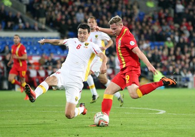 11013 - Wales v Macedonia, World Cup 2014 Qualifying - Wales' Simon Church fires at goal as Macedonia's Vance Sikov closes in(c) Huw Evans Picture Agency, Cardiff