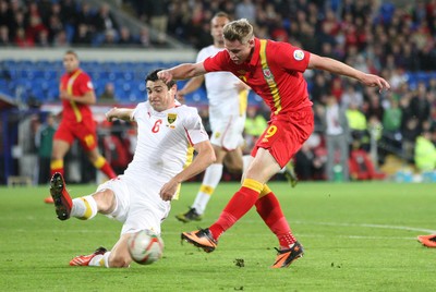 11013 - Wales v Macedonia, World Cup 2014 Qualifying - Wales' Simon Church fires at goal as Macedonia's Vance Sikov closes in(c) Huw Evans Picture Agency, Cardiff